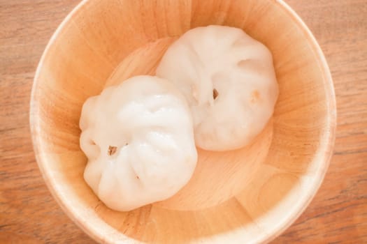 Steamed dumpling stuff on wooden bowl, stock photo