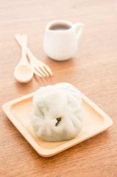 Steamed dumpling stuff serving on wooden plate, stock photo
