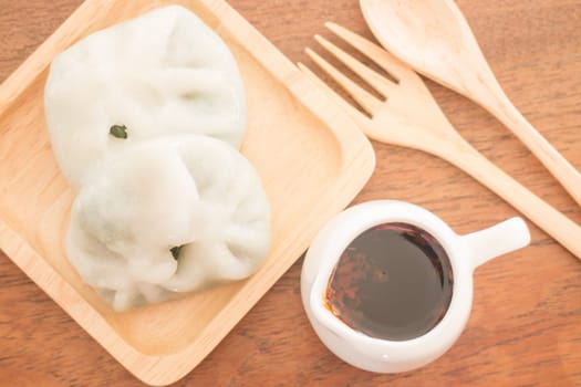 Steamed dumpling stuff serving on wooden plate, stock photo