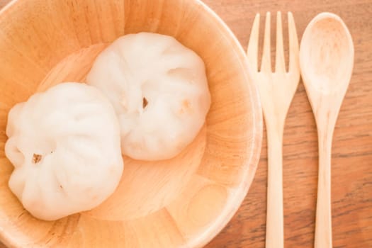 Steamed dumpling stuff on wooden bowl, stock photo