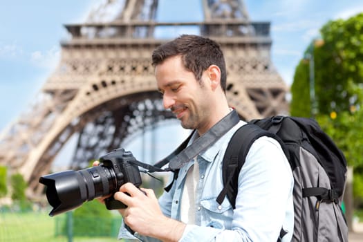 View of a Young attractive tourist taking pictures in Paris, France