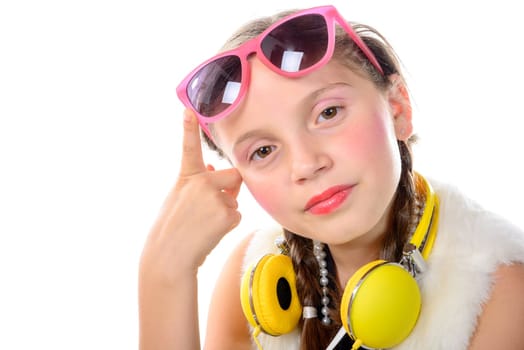 a pretty little girl with pink glasses and yellow headphones on the white background