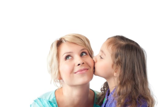 little daughter kissing her young and happy smiling mother. Studio shot, isolated on white background