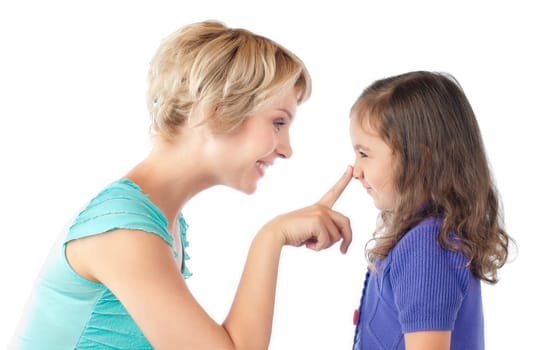 beautiful and happy young mother and small daughter smiling and looking at each other. Mother pushing daughter on nose with her finger. Studio shot, isolated on white background