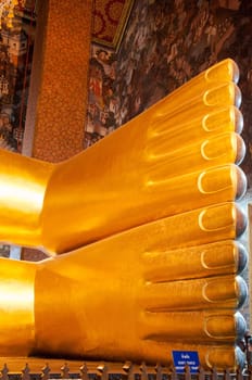 Feet detail of Reclining Buddha gold statue in Wat Pho buddhist temple, Bangkok, Thailand