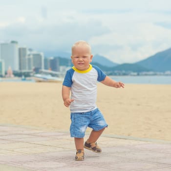 Baby walking along the beach