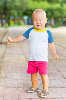 Baby walking along the beach
