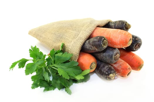orange and purple carrots in a jute sack