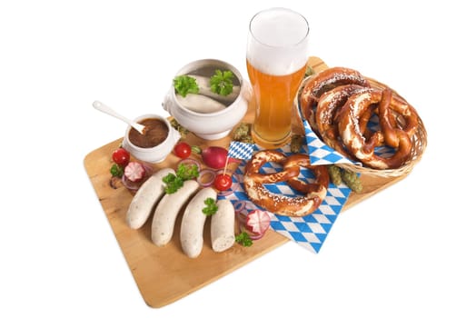 White sausage breakfast with sausages,pretzels,white beer and sweet mustard on wooden board