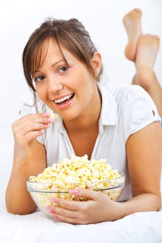 Young woman eating popcorn isolated on white background