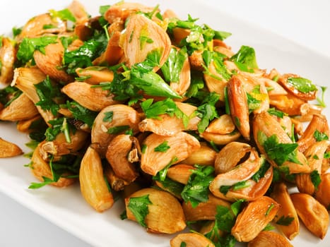 Salad with baked garlic and freshly chopped parsley