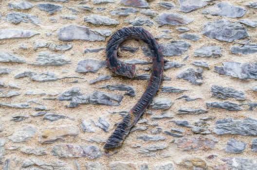 Old castle stone wall with number no. 9 made of wrought iron. Texture Background