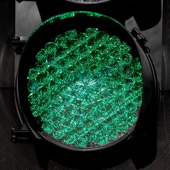 LED powered traffic light, shining green, viewed up close.