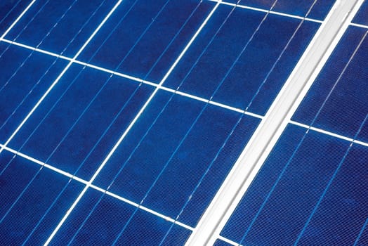 An up close view of a solar panel revealing the squares within which the individual solar strips are positioned as seen from a diagonal angle.