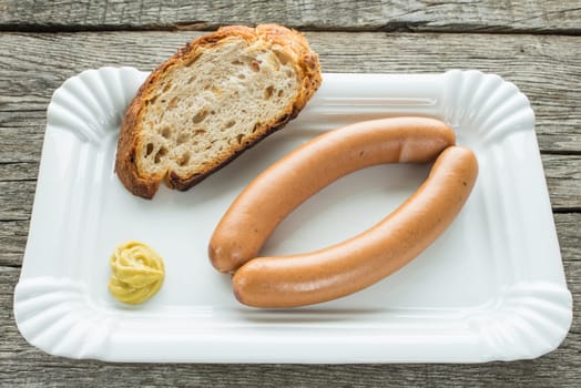 Pair of Viennese sausages with mustard and bread