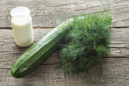 Yoghurt,cucumber and dill on a rustic table