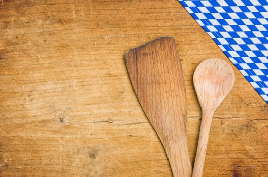 Cooking spoon with a Bavarian tablecloth
