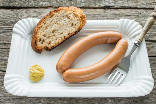 Viennese sausages with fork and mustard