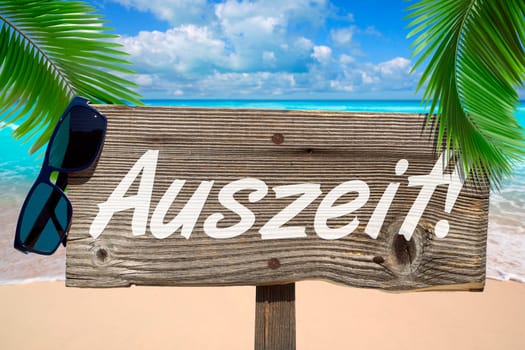 Wooden sign with the inscription "Time out"" under palm trees on the sandy beach"