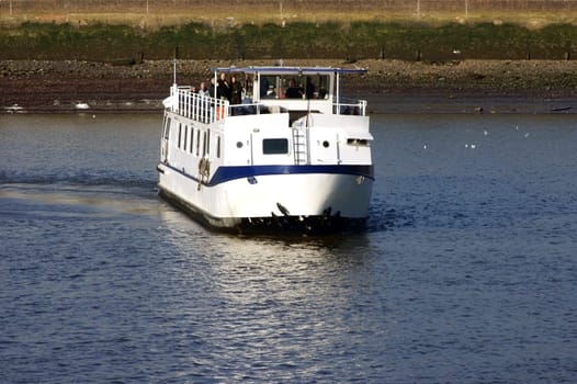 London,United Kingdom – November 29,2014: A boat cruise on the Thames with visitors and tourists docks in Greenwich on November 29,2014 in London.
