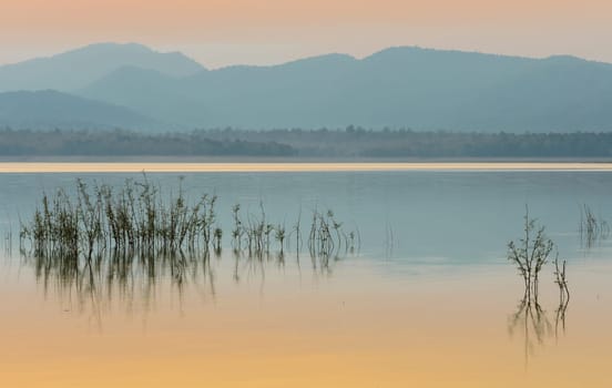 Beautiful sunset over the mountain with reflection on lake