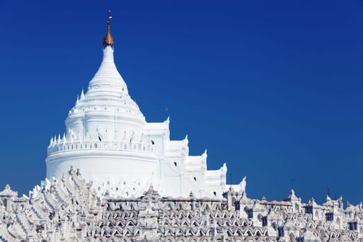 The Hsinbyume Pagoda is a large pagoda on the northern side of Mingun in Sagaing Region, on the western bank of the Irrawaddy River. It is approximately 10km northwest of Mandalay and is located in the proximity of the Mingun Pahtodawgyi. The pagoda is painted white and is modeled on the physical description of the Buddhist mythological mountain, Mount Meru. It is based on descriptions of the mythical Sulamani pagoda on Mount Meru, and the lower parts of the pagoda represent the mountain. Seven concentric terraces represent the seven mountain ranges going up to the Mount Meru according the Buddhist mythology