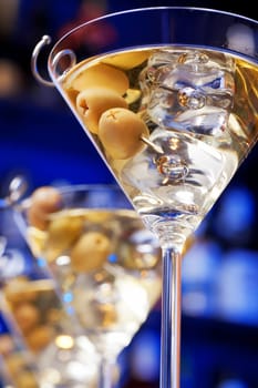 Several glasses of famous cocktail Martini, shot at a bar with shallow depth of field..Ingredients