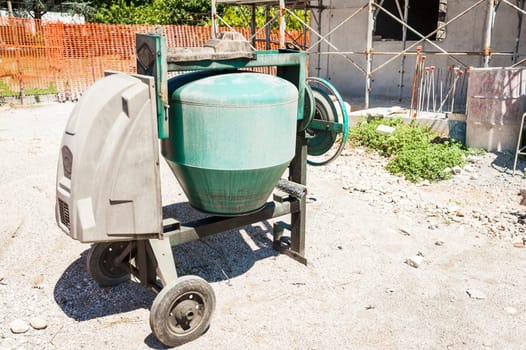 Industrial cement mixer machinery at construction site.