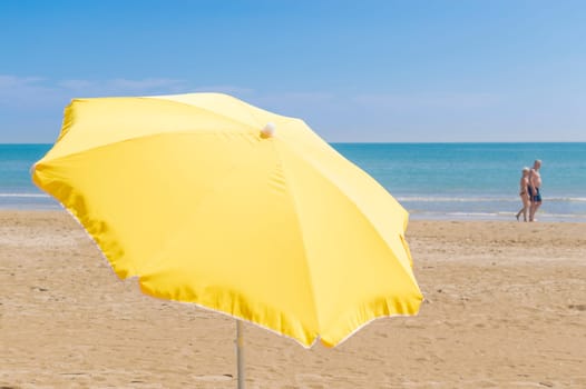 Umbrella on the beach, with the sea and sky in the background