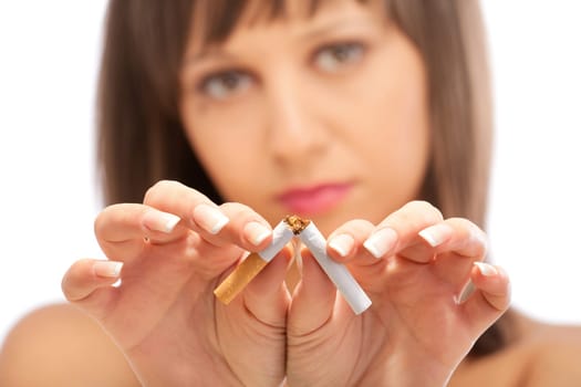 Young woman breaking a cigarette - close up of her hands