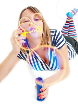 Girl blowing bubbles, isolated on white