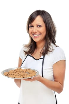 Young woman holding a tray with homemade chocolate cookies, looking at camera