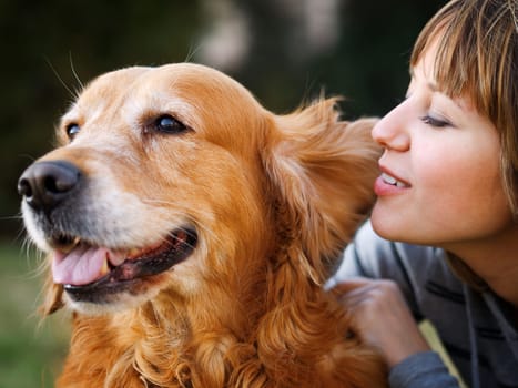 Girl whispering in her dog's ear