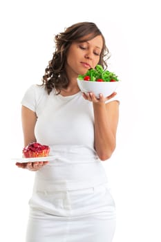 Young woman choosing sweets or healthy eating - one portion of cake and a healthy salad