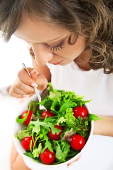 Youg woman eating healthy salad isolated on white background