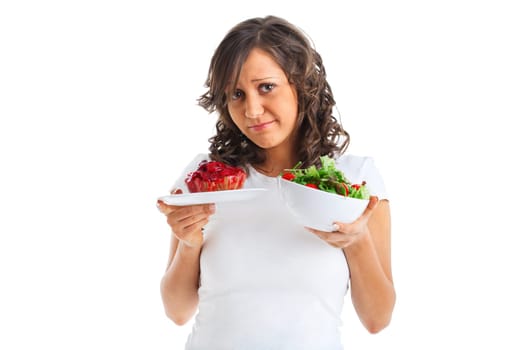 Young woman choosing sweets or healthy eating - one portion of cake and a healthy salad