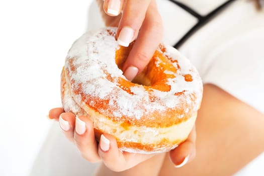 Donut in woman's hand, close up