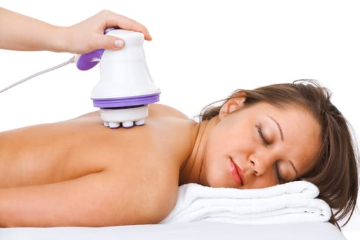 Young woman having a classical massage lying on white bed