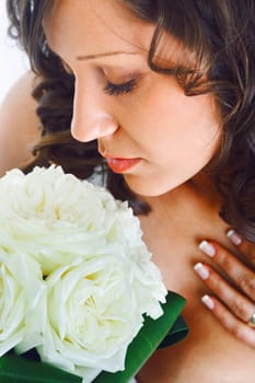 Young bride with wedding bouquet isolated on white background