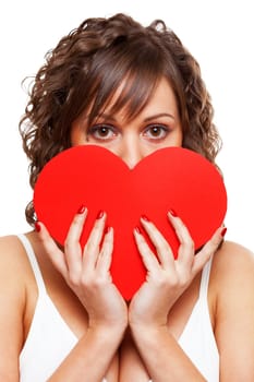 Young attractive woman holding red paper heart like a valentine card