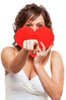 Young attractive woman holding red paper heart like a valentine card