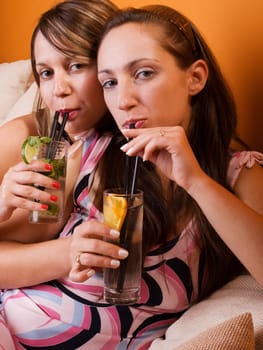 Girls in dresses with cocktails