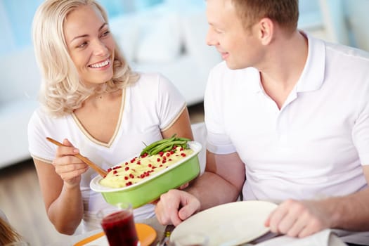 Happy married couple having dinner at home