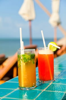 Two glasses of Mai Thai and Mojito Cocktails at the pool in a family hotel in Ko Samui, Thailand