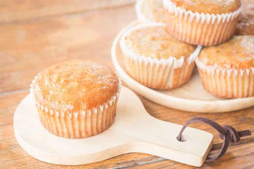 Homemade banana muffins on wooden plate, stock photo