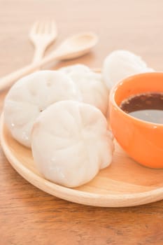 Steamed dumpling stuff on wooden plate, photo