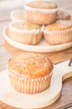 Homemade banana muffins on wooden plate, stock photo