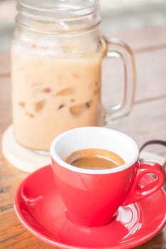 Hot and cold coffee on wooden table, stock photo