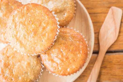Homemade banana muffins on wooden plate, stock photo