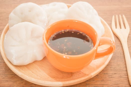 Steamed dumpling stuff on wooden plate, photo